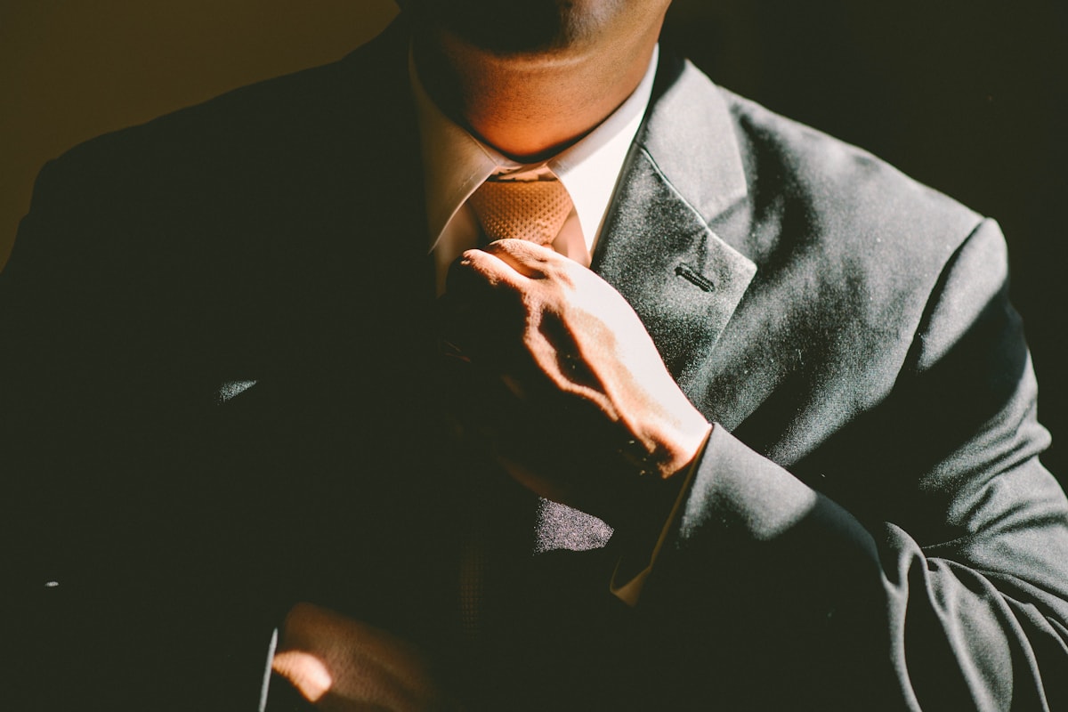 A businessman adjusting his tie