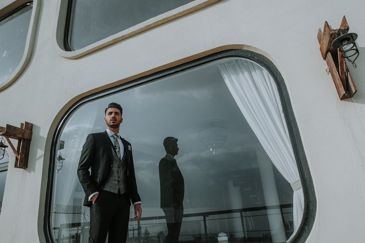 A suited professional and his reflection in glass